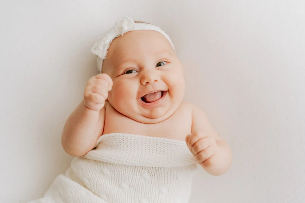 a baby with a white hat